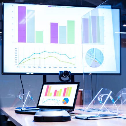 Laptop and television with presentation slideshow in meeting room